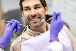 Man smiling during his visit with his dentist